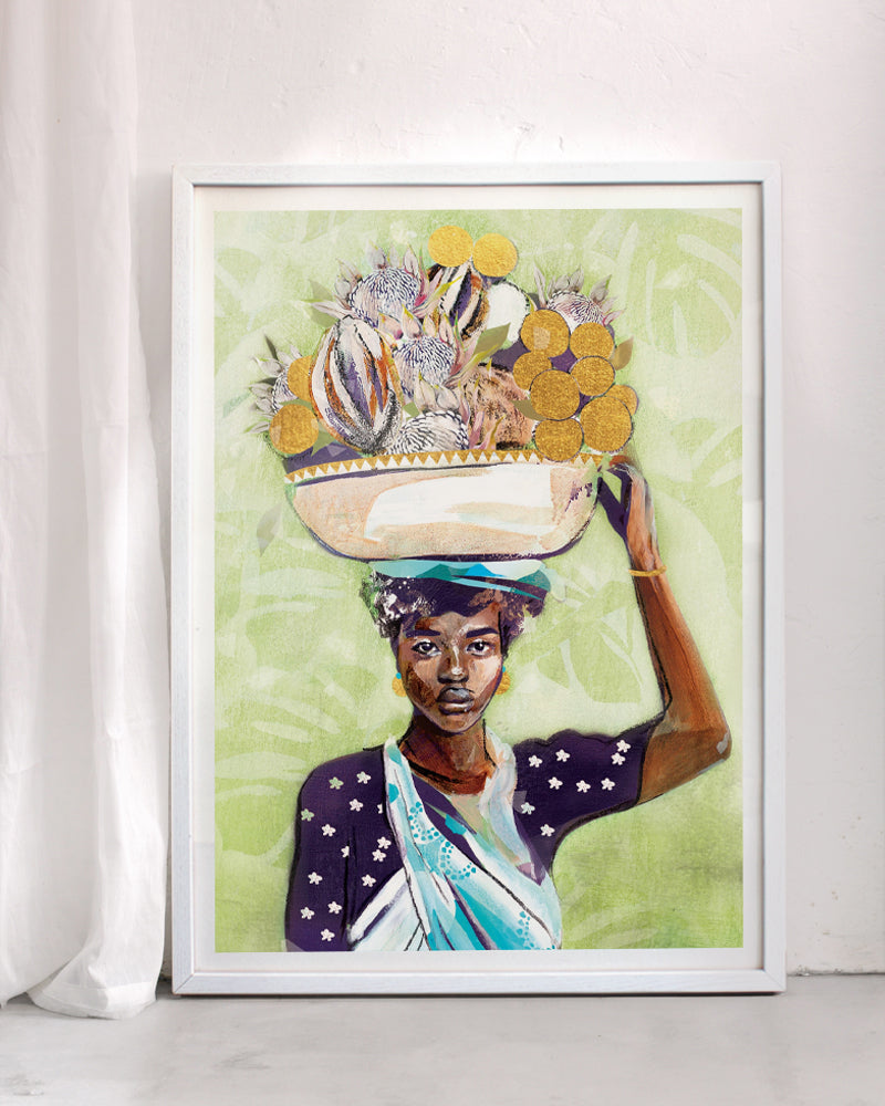 An art print of a woman holding a basket of fruit n her head. Framed in a white frame with a curtain next to it.