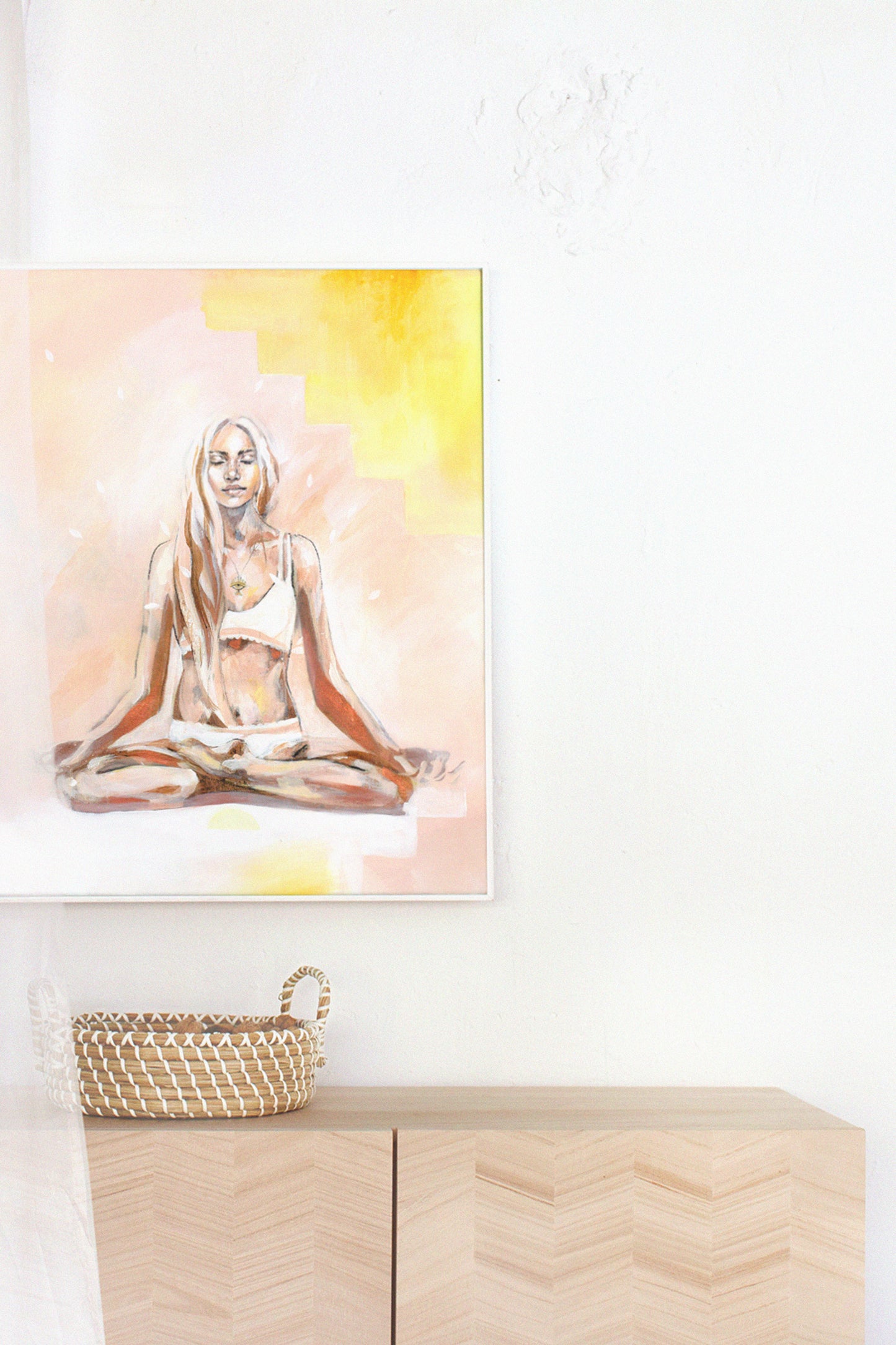 Bohemian interior with a yoga artwork. Lotus pose mediation in yellow and pink.