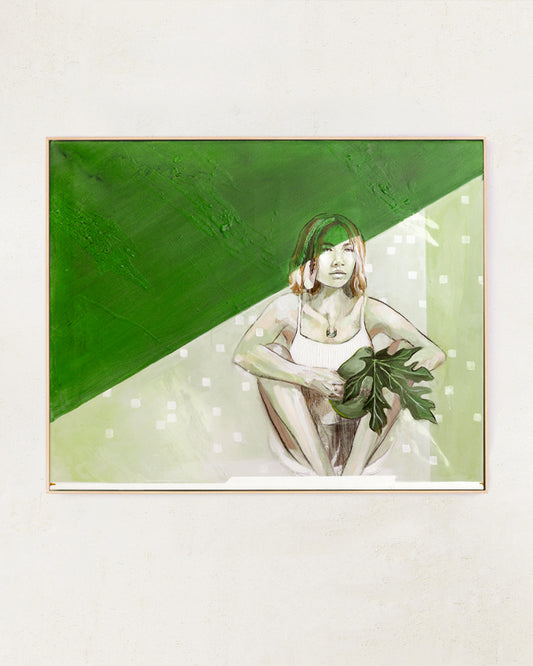 Painting of a woman in green framed in a wooden frame hung on a wall.
