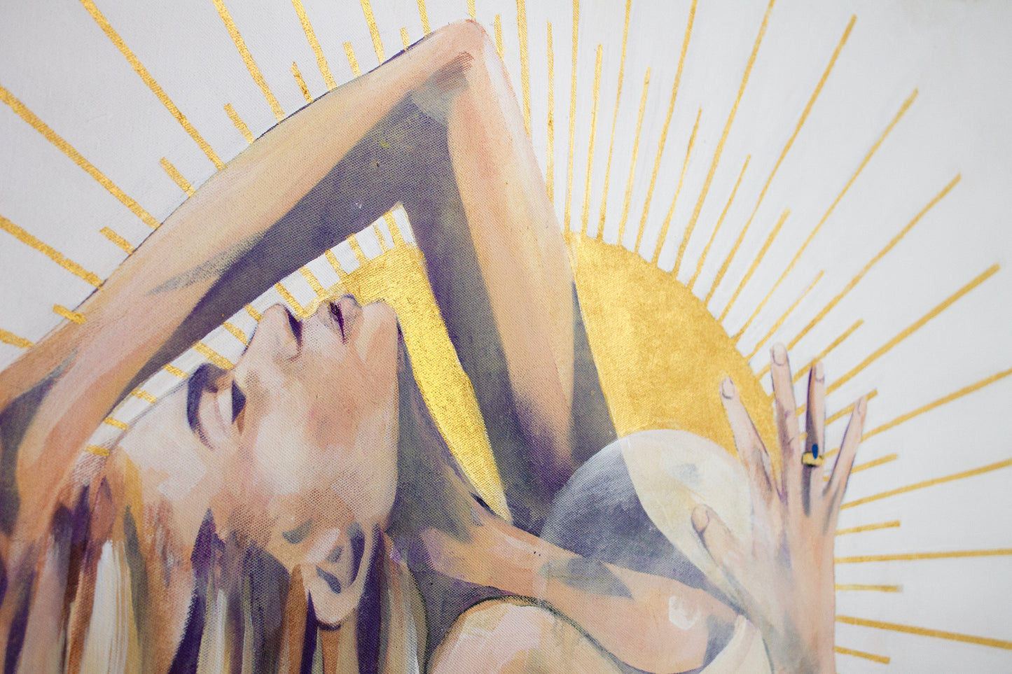 Close up detail of the face and sun in painting I am the Sun. Gold and yellow