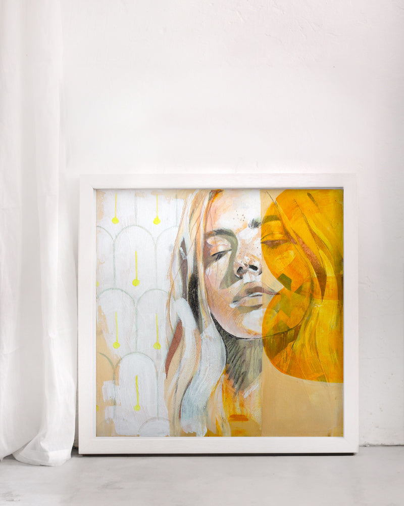 Warm and bright art print of a woman portrait. Mediterranean tiles are in the background. Framed in a white frame in on a white background. Mallorca style interior.