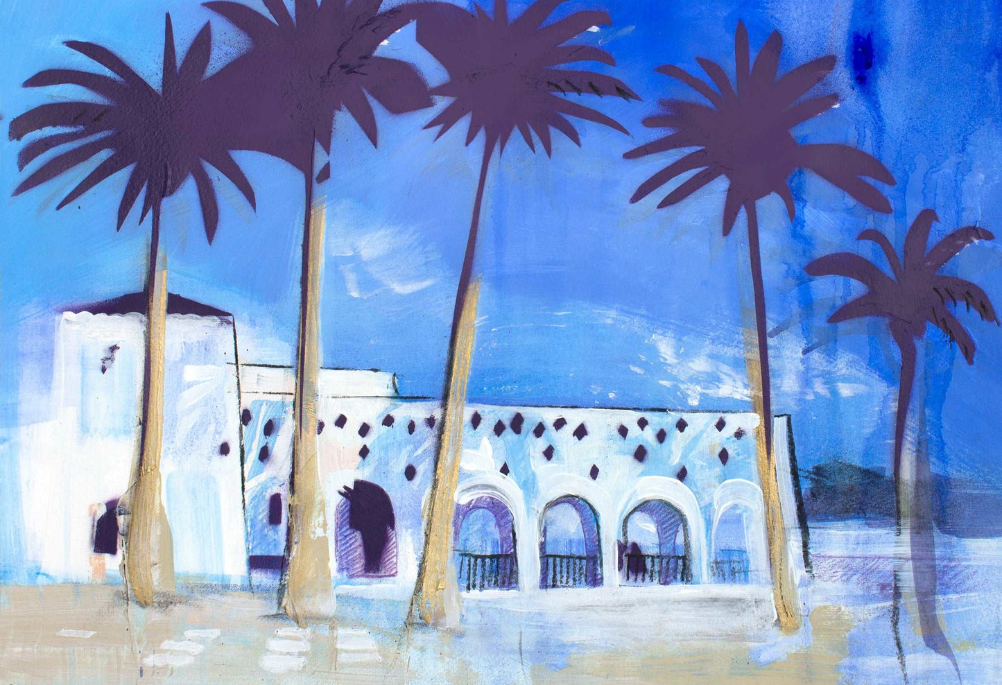 Palm trees and white washed buildings against a pure blue sky.