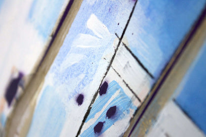 Close up detail of painting in white and blue with viable brush strokes.