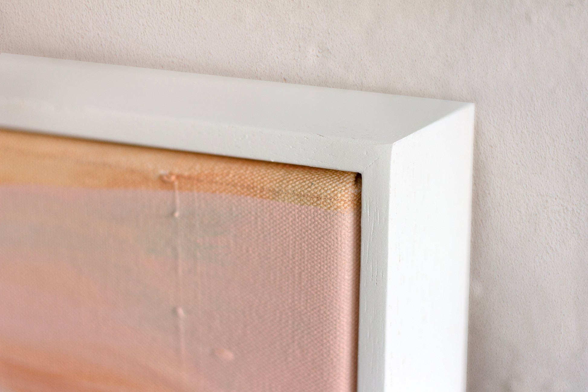 Close up detail of a white wooden tray frame for painting Aura by Hannah Adamaszek.