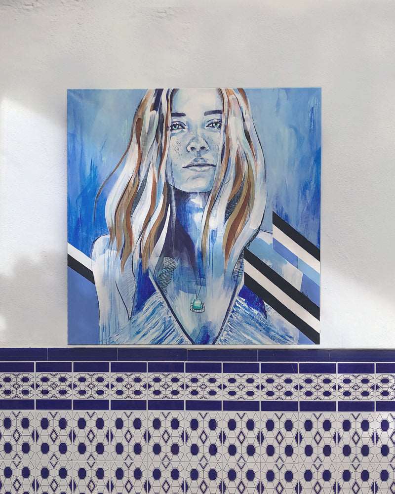 Mediterranean blues in contemporary portrait of a strong woman. Having on a wall with Spanish tiles.