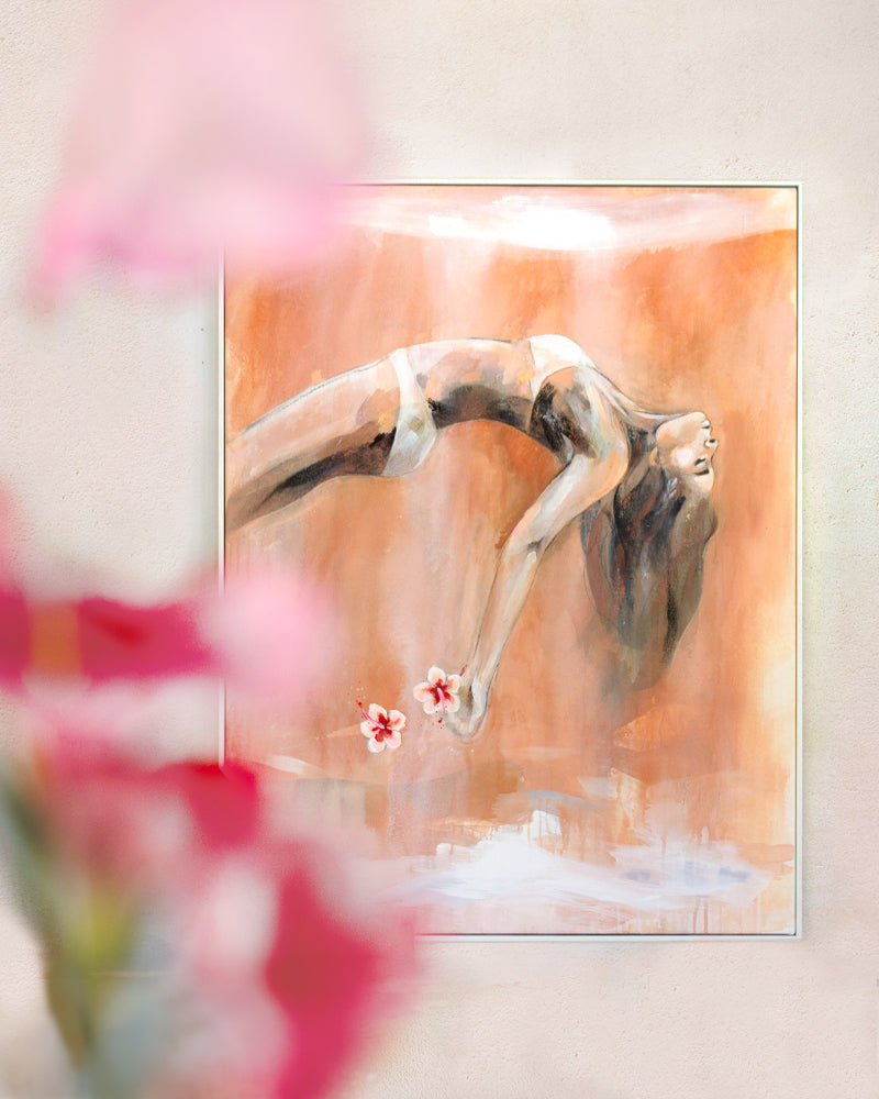 An abstract painting of a woman in a backbend, holding two flowers, with warm earthy tones. Blurred pink flowers in the foreground add depth and framing.