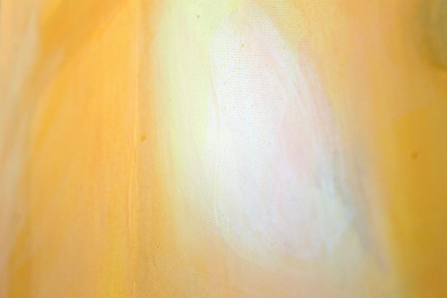 Close up art detail with the texture of the canvas and paint. Orange leading to a white glow.