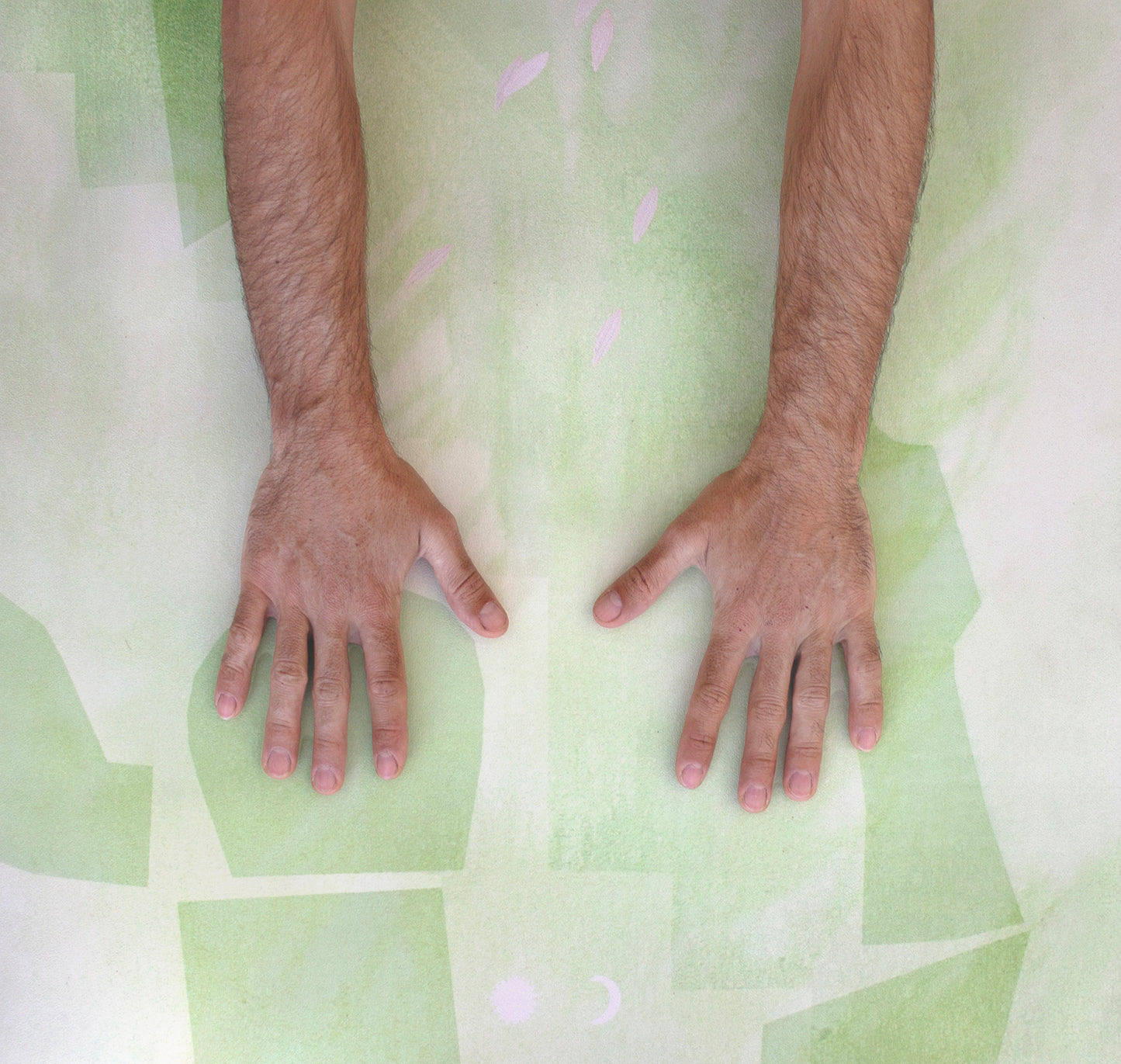 Man’s hands pressing into the vegan suede surface of the Algae Forest eco yoga mat by Hannah Chloe, showing natural rubber grip and texture.