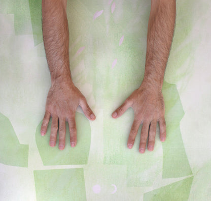 Man’s hands pressing into the vegan suede surface of the Algae Forest eco yoga mat by Hannah Chloe, showing natural rubber grip and texture.