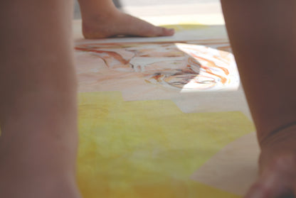 Apricot Glow eco yoga mat by Hannah Chloe displayed during yoga practice — natural rubber base and non-slip vegan suede surface in warm apricot tone.