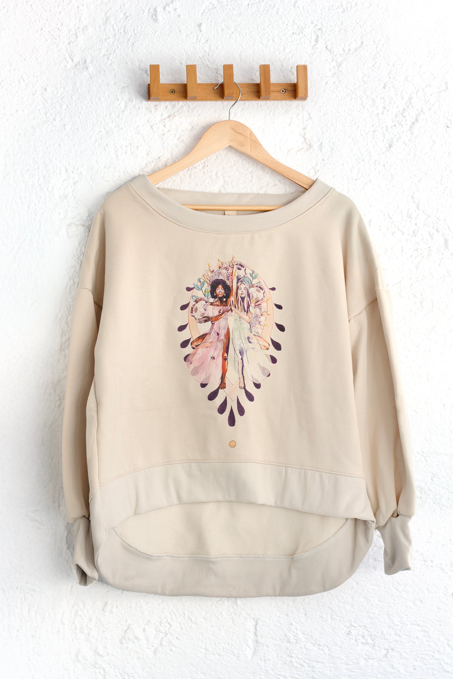 Beige organic cotton sweatshirt featuring the Grounded artwork by Studio Hannah Chloe — a yoga-inspired design symbolising balance and connection.
