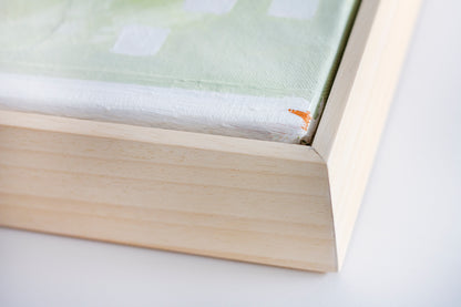 Close up art detail of the natural wood frame of painting Nourish by Hannah Adamaszek.